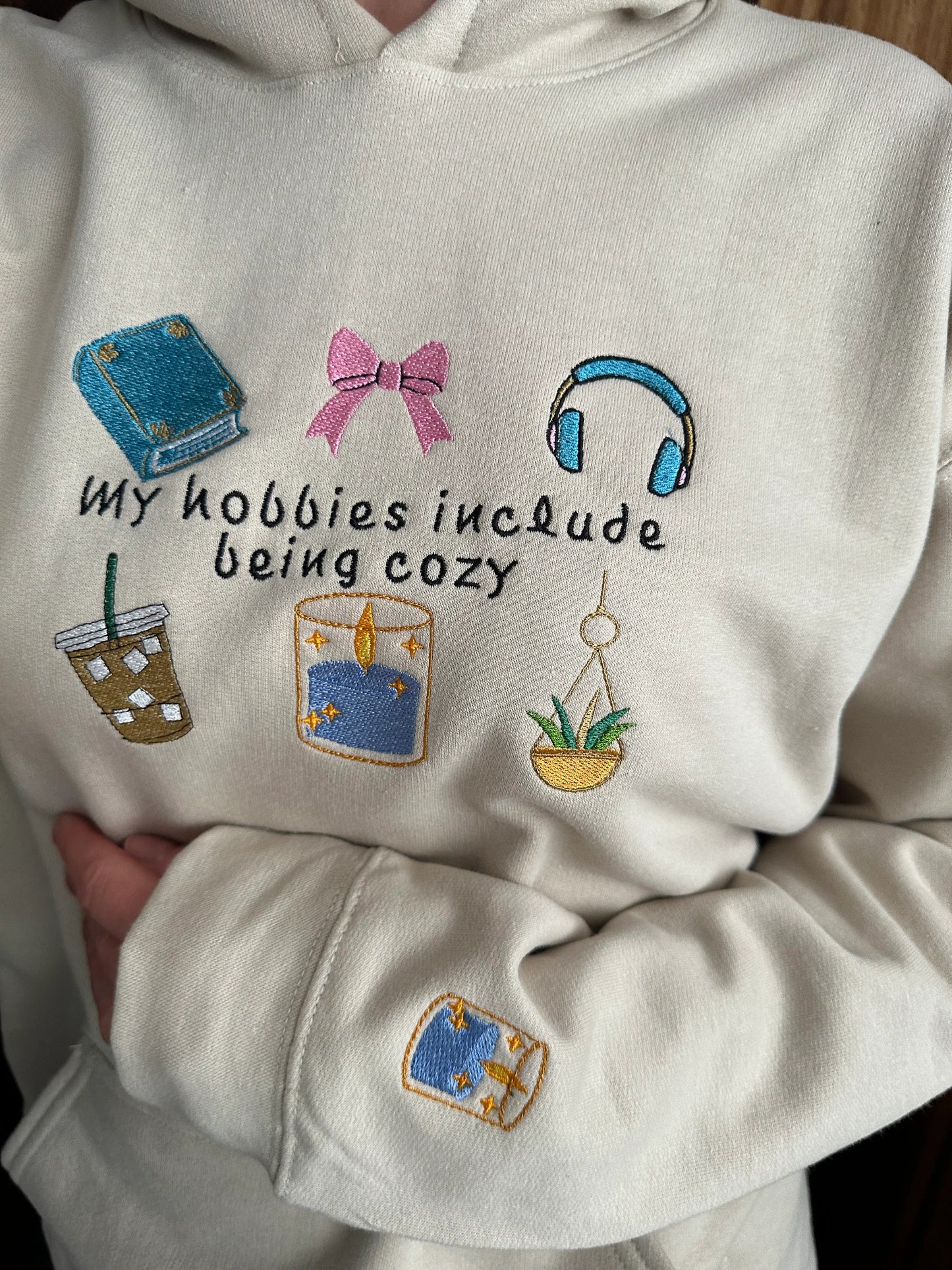 Embroidered hoodie with a quote ''My Hobbies Include Being Cozy'' with embroidered Sleeve