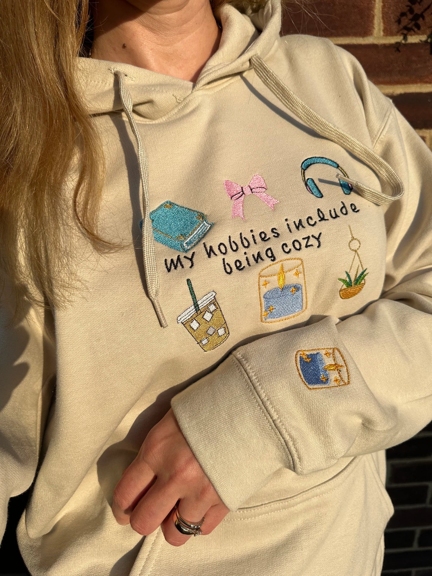 Embroidered hoodie with a quote ''My Hobbies Include Being Cozy'' with embroidered Sleeve